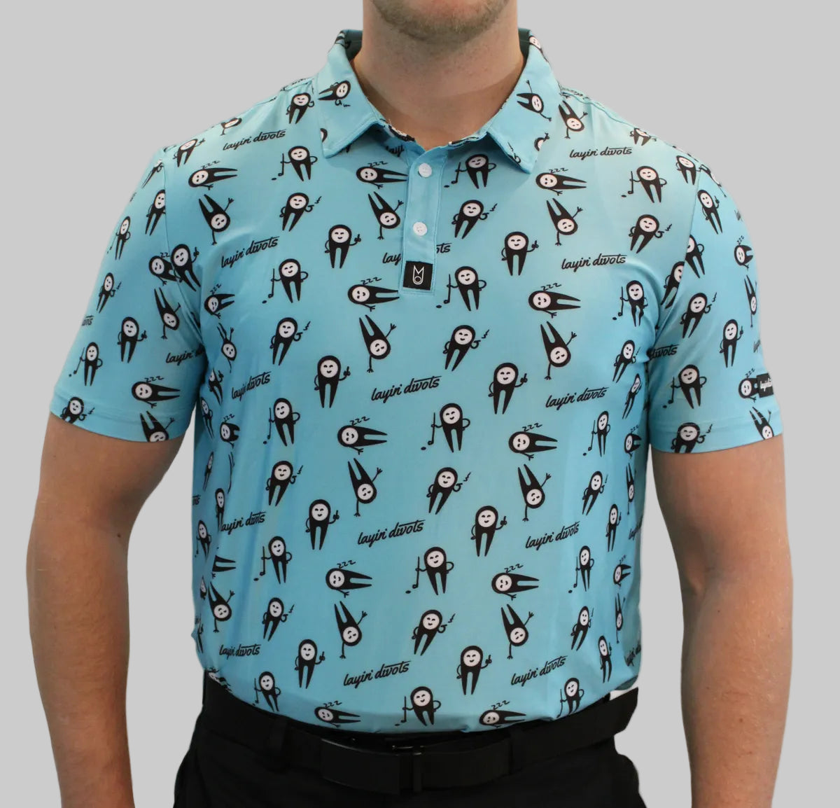 Man wearing a light blue polo shirt with black and white graphic design on a plain background